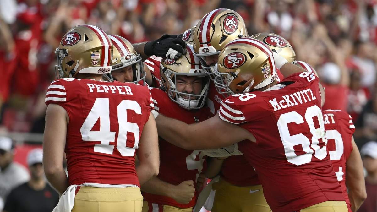 Jake Moody, al centro, celebra con sus compañeros de equipo después de patear el gol de campo de la victoria en los últimos instantes del partido