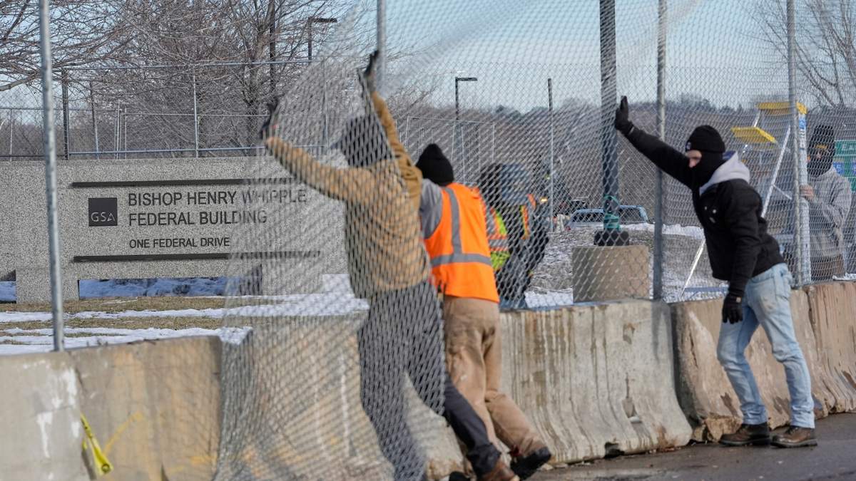 Obreros erigen una cerca en torno al Bishop Whipple Federal Building en Minneapolis
