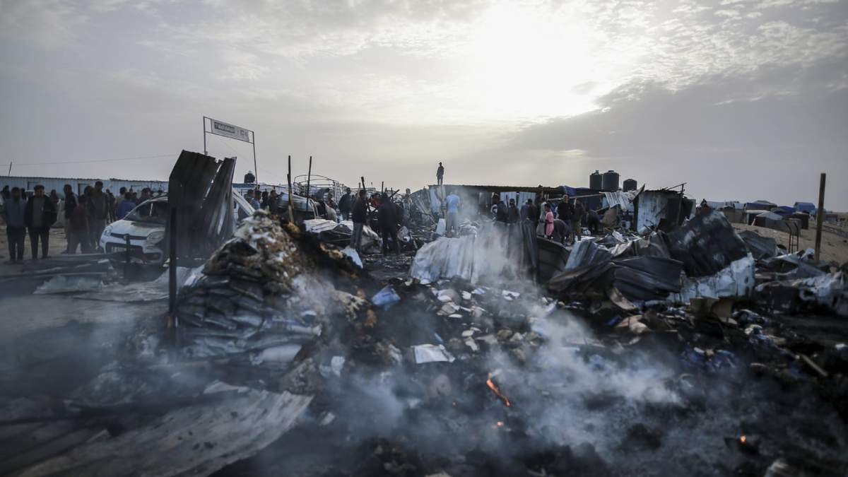 Palestinos observan la destrucción después de un ataque israelí donde los desplazados se alojaban en Rafah, Franja de Gaza