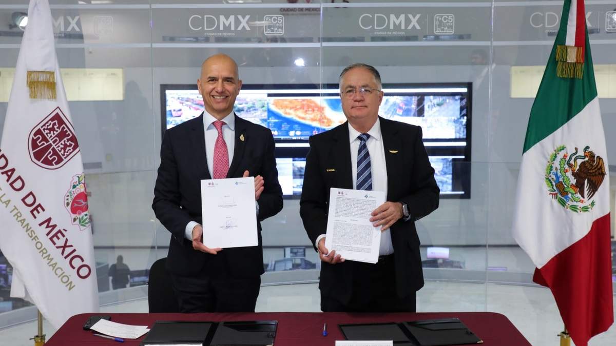 El titular del C5, Salvador Guerrero Chiprés, y el director general del AICM, el almirante Juan José Padilla Olmos, firman el convenio para ampliar la cobertura perimetral de la videovigilancia en el aeropuerto capitalino