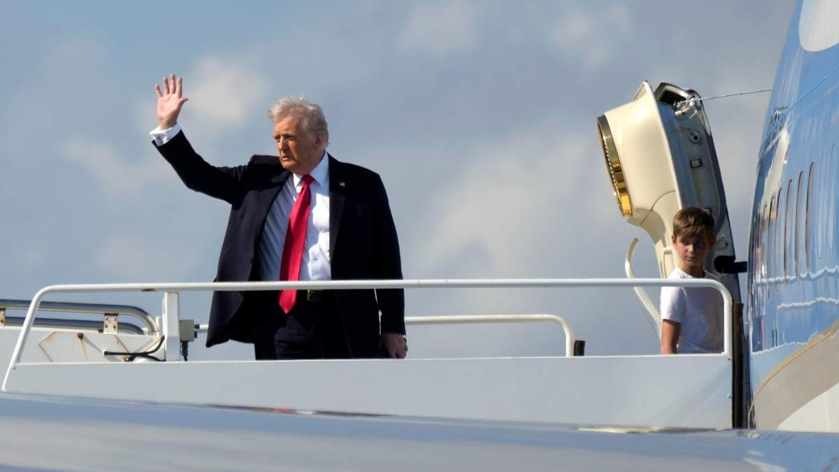 El presidente Donald Trump, a la izquierda, saluda mientras sube al Air Force One con su nieto Theodore, hijo de Ivanka Trump, en el Aeropuerto Internacional de Palm Beach en West Palm Beach, Florida