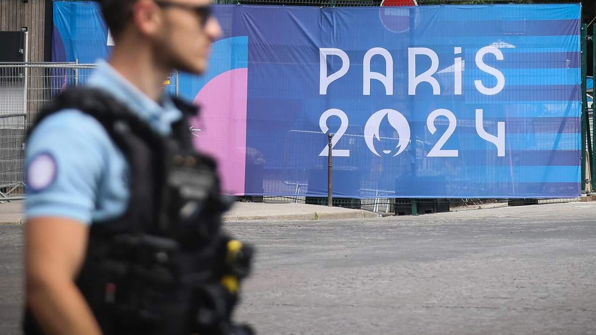 Un oficial de policía camina junto a un letrero de los Juegos Olímpicos de París el sábado 20 de julio del 2024
