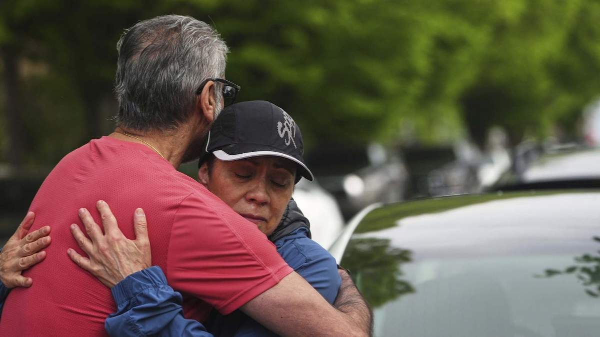 Esperanza Bermudez, quien vive frente a la calle, recibe consuelo de sus amigo Manjit Claire, de rojo, momentos después de que un conductor mató a varias personas al embestir con su auto un festival de la comunidad filipina