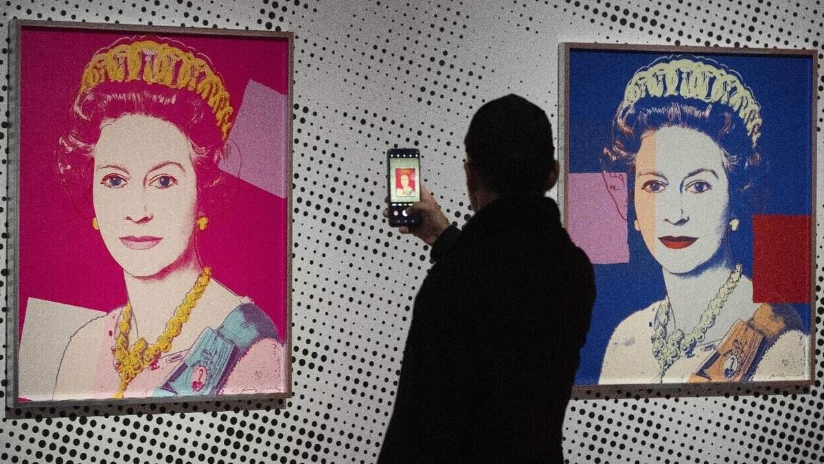 Un hombre toma una foto de una impresión en serigrafía que muestra a la Reina Isabel II, parte de la serie de dieciséis impresiones de cuatro reinas, titulada Reigning Queens, 1985, de Andy Warhol, en el museo Paleis Het Loo en Apeldoorn, Holanda, el miércoles 9 de octubre de 2024, similares a las obras del artista robadas de una galería de Oisterwijk, Holanda, en las primeras horas del viernes 1 de noviembre de 2024
