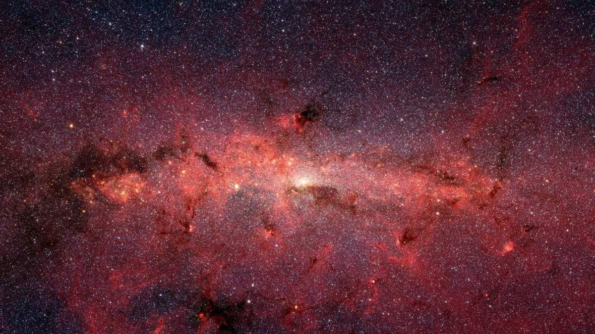 Imagen del centro de la galaxia obtenida con el telescopio espacial Spitzer, donde se pueden ver zonas de nubes moleculares, entre ellas, la nube en la que se ha descubierto la etanolamina