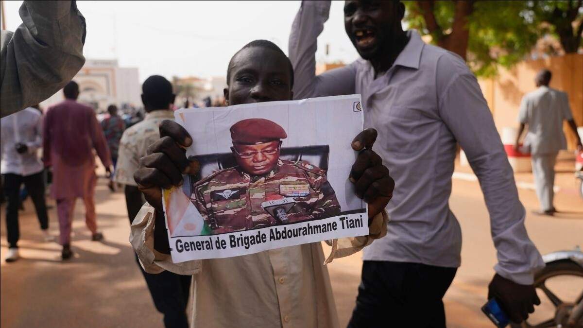 Nigerinos participan en una marcha convocada por los partidarios del general que encabezó un golpe de Estado, Abdourahmane Tchiani (en la foto), en Niamey, Níger