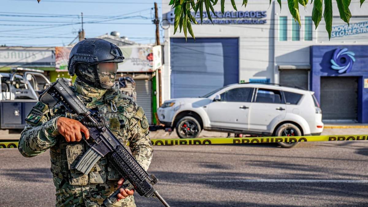 Un elemento de las fuerzas armadas resguarda la escena de un un enfrentamiento armado en la Calzada Aeropuerto, que dejó un  agente de la Policía Estatal Preventiva sin vida y dos elementos de la Guardia Nacional heridos, Culiacán, Sinaloa