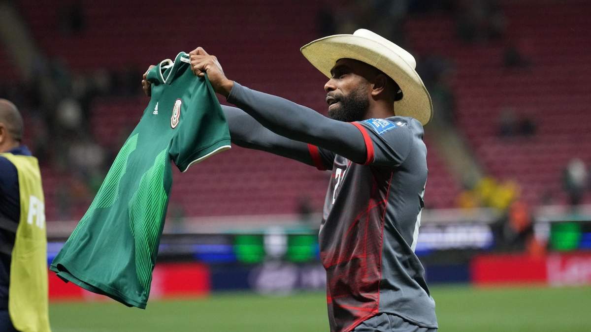 Germain Haewegene, de Nueva Caledonia, sostiene una camiseta de la selección mexicana después de caer ante Jamaica en el repechaje mundialista
