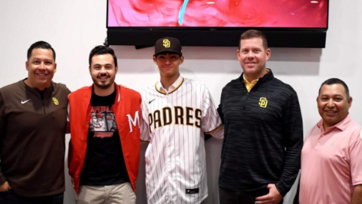 Humberto Cruz (centro) durante su firma con los Padres de San Diego
