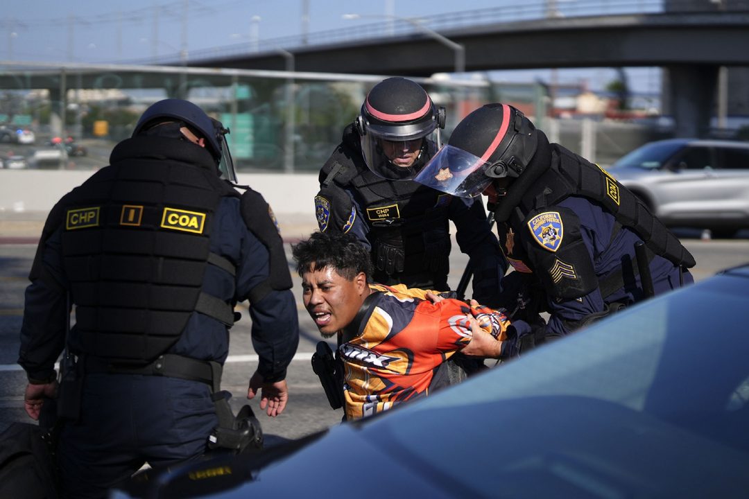 10 de junio. Un manifestante es arrestado por la Patrulla de Carreteras de California, cerca del edificio federal en el centro de Los Ángeles. Foto APEric Thayer.