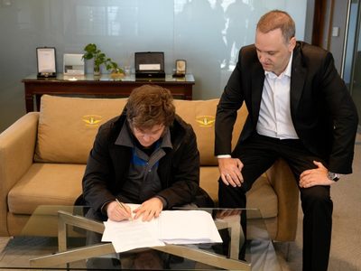 Con el mameluco de YPF, Milei firmó el proyecto de reforma laboral