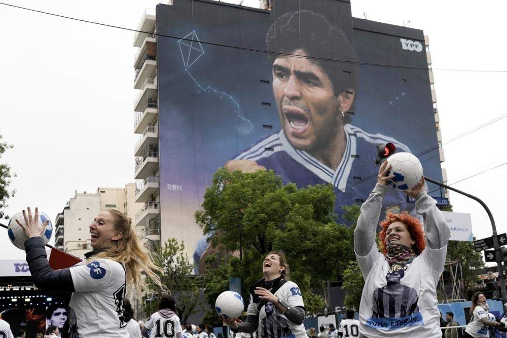 Mujeres juegan con balones durante la inauguración del mural de Diego Maradona, del artista Martín Ron, en Buenos Aires, Argentina, el 30 de octubre de 2022