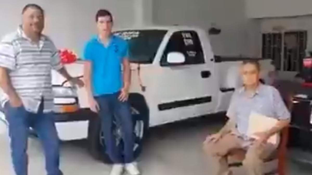 Juan Manuel, sentado en la silla, con el ganador del sorteo de la camioneta