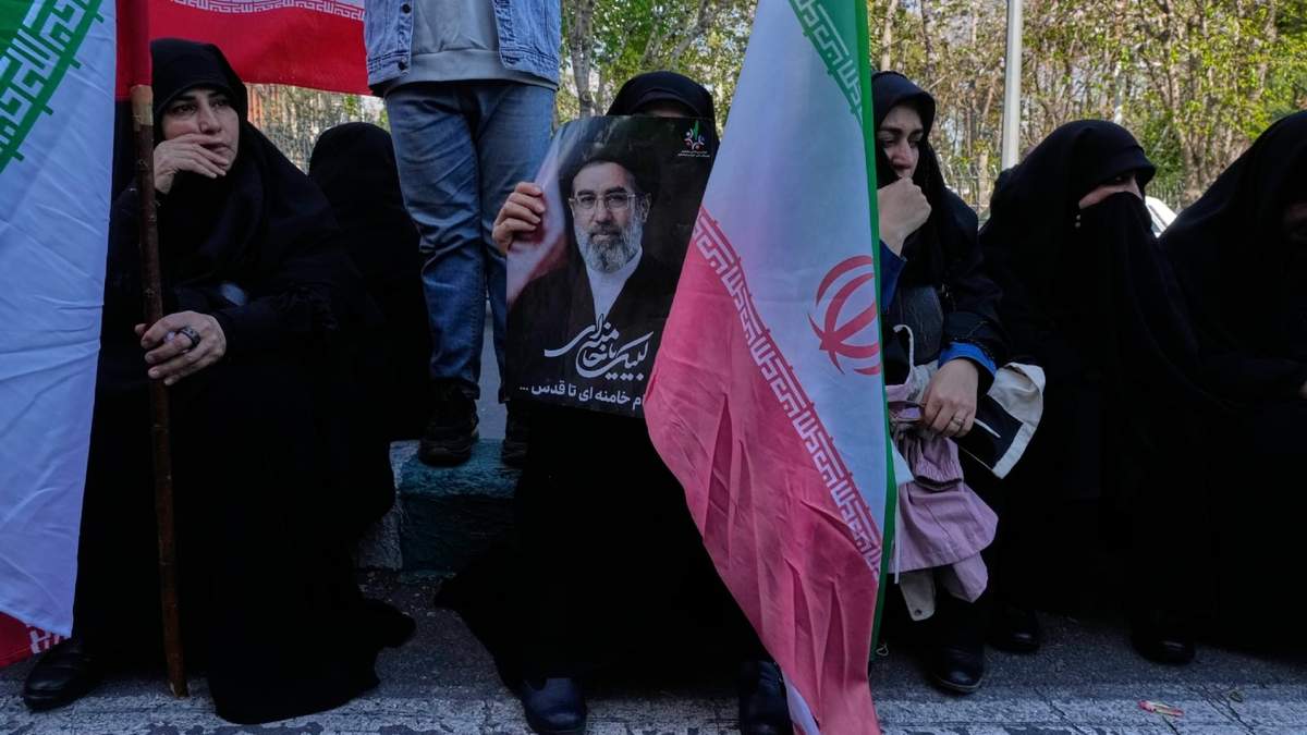 Mujeres sostienen banderas iraníes y una fotografía del líder supremo iraní, el ayatolá Mojtaba Khamenei, en el centro de Teherán, Irán
