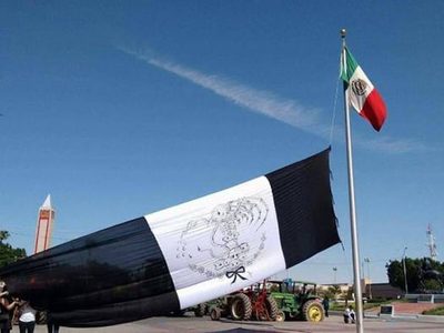 Integrantes de 'Mexicali resiste” izan bandera negra de México