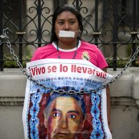 Padres de los 43 se encadenan a rejas de la Segob; exigen permanencia del GIEI