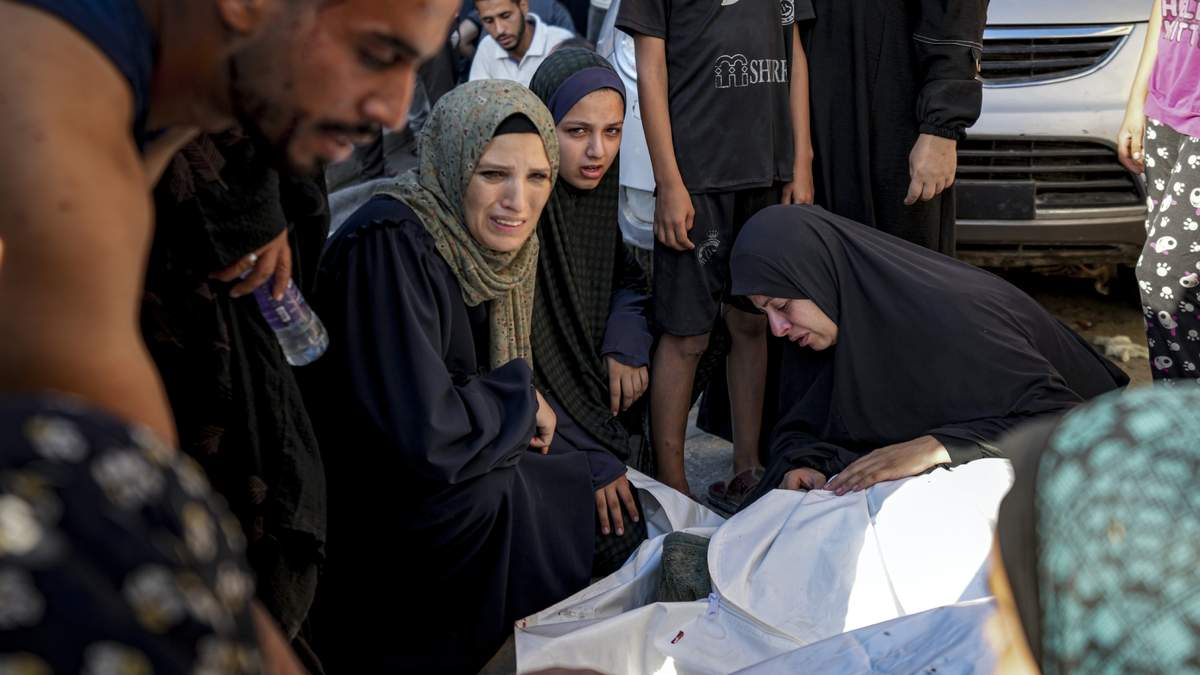 Palestinos lloran a un familia muerto en un bombardeo israelí en la Franja de Gaza, en un hospital de Deir al-Balah