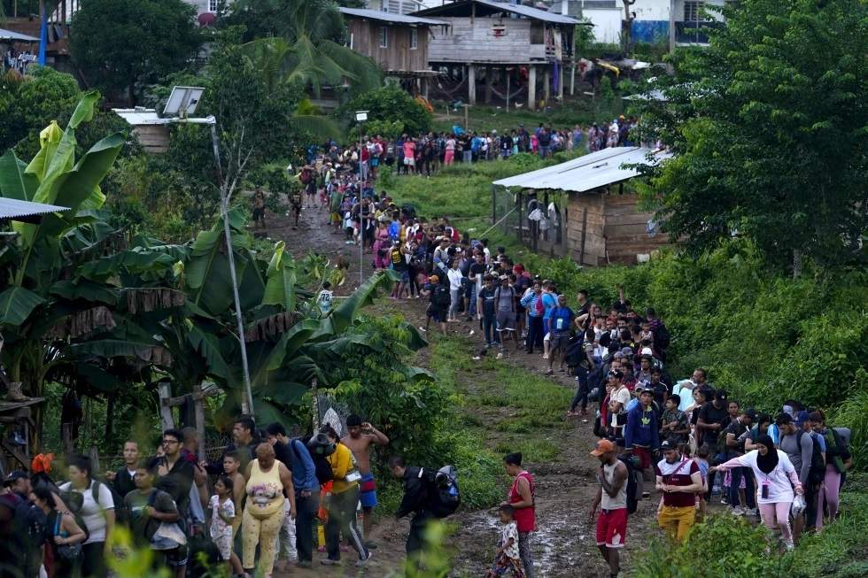 Migrantes que buscan llegar a Estados Unidos hacen fila para tomar un bote en Bajo Chiquito, en la provincia de Darién en Panamá, el jueves 5 de octubre de 2023.