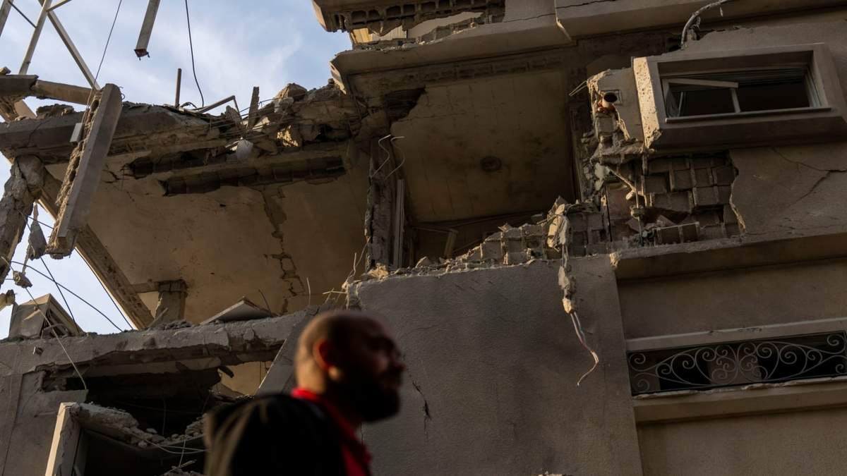 Un hombre observa los daños causados en un edificio por proyectiles lanzados desde Líbano, en Tira, en el centro de Israel