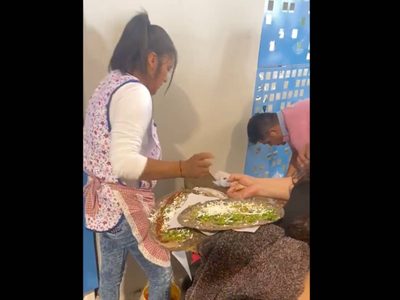 Una señora instala su puesto de tlayudas en el AIFA; aprovecha que no hay locales de comida
