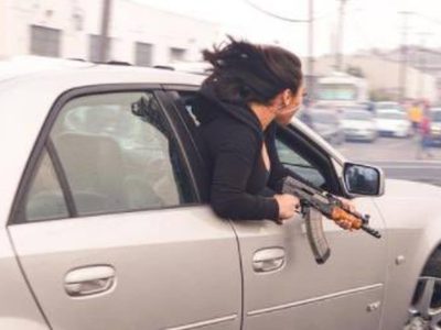Una mujer exhibe una AK-47 desde un Cadillac en una carrera ilegal en San Francisco