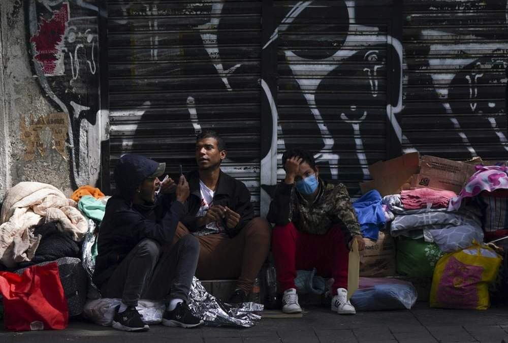 Migrantes venezolanos esperan ayuda afuera de la Comisión Mexicana de Ayuda a Refugiados en la Ciudad de México