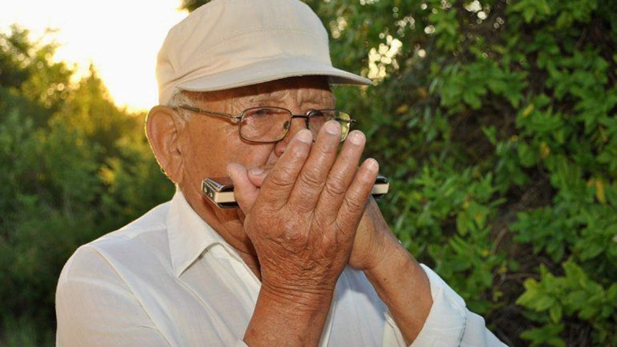 Don Nolberto y su armónica, una historia de vida.Fuente. (Twitter)
