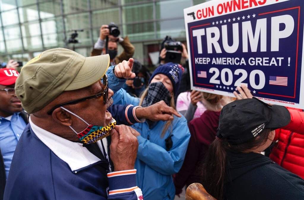 Partidarios de Trump y de Biden discuten los resultados electorales frente a la junta central de escrutinio en Detroit, Michigan. Foto AP / David Goldman.