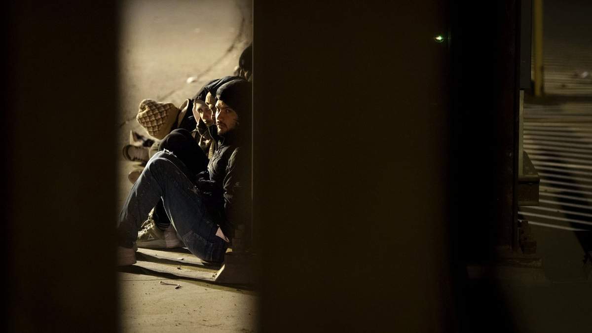 21 de enero. Migrantes esperan a ser procesados entre dos muros fronterizos que separan México de EU, tras cruzar de forma ilegal en San Diego
