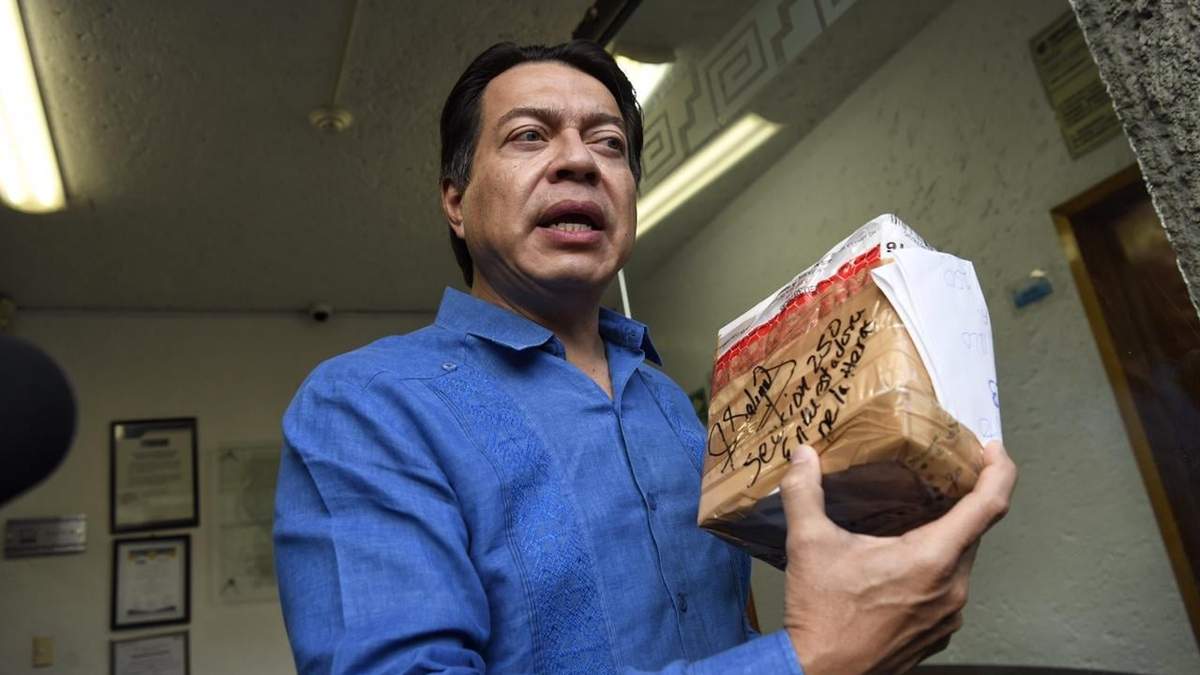 Mario Delgadp sostiene uno de los paquetes con las boletas de las encuestas levantadas