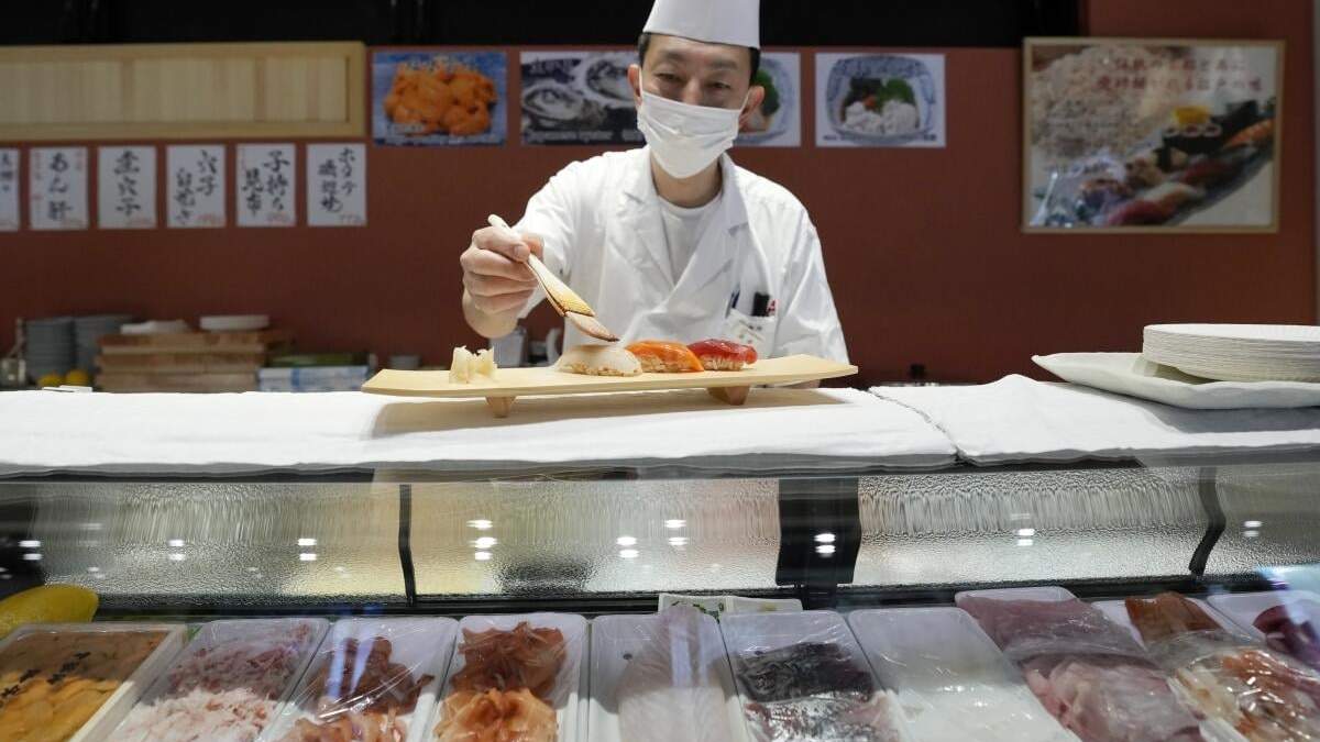ARCHIVO - Un chef de sushi prepara un platillo en el mercado Toyosu, el lunes 29 de enero de 2024, en Tokio