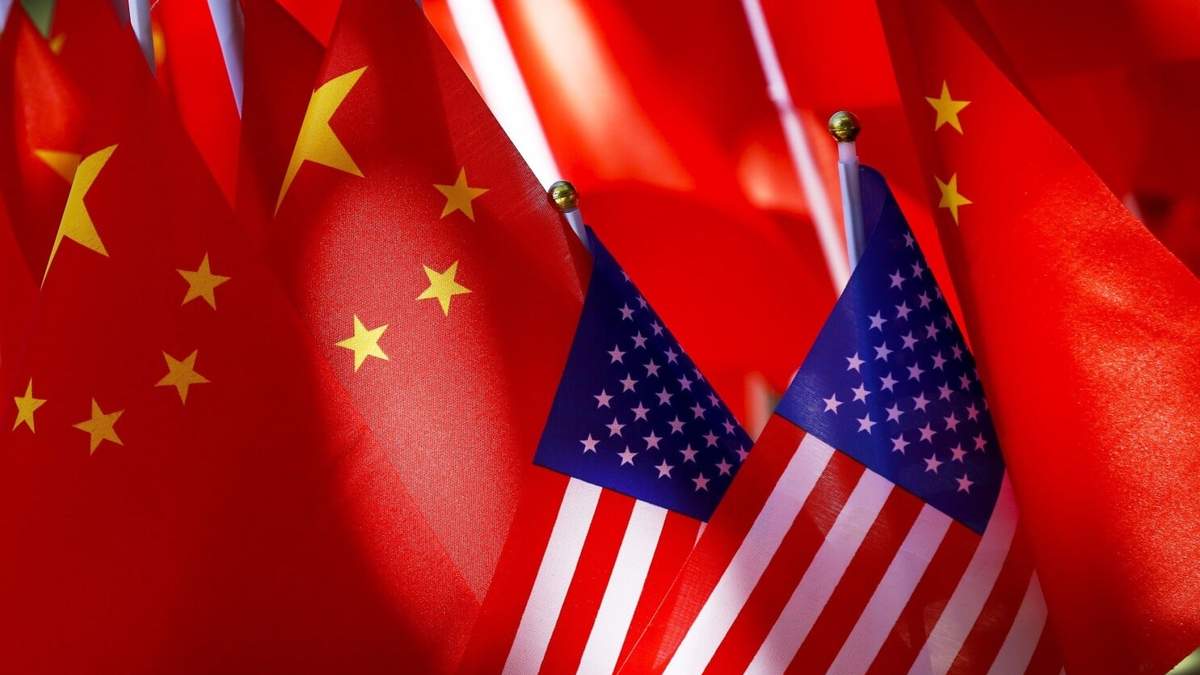 En esta imagen de archivo, banderas estadounidenses y chinas en Beijing