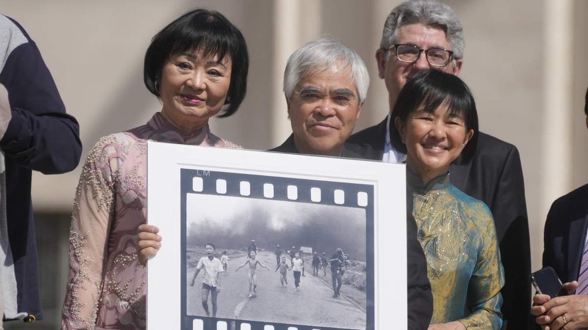 El fotógrafo ganador del Premio Pulitzer, Nick Ut, en el centro, flanqueado por Kim Phuc, a la izquierda