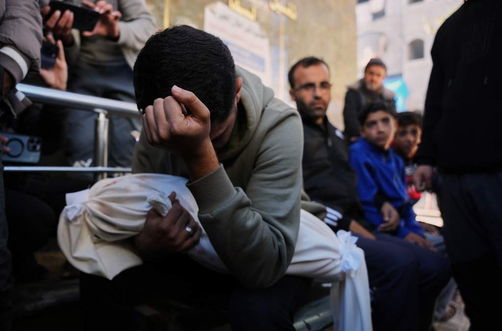 Mohammed al-Neder, de 21 años, llora el cuerpo de su hermano Ahmed, de 4 meses, quien murió por fuego israelí pese al alto al fuego, durante su funeral en el Hospital Shifa en la ciudad de Gaza, el sábado 20 de diciembre de 2025