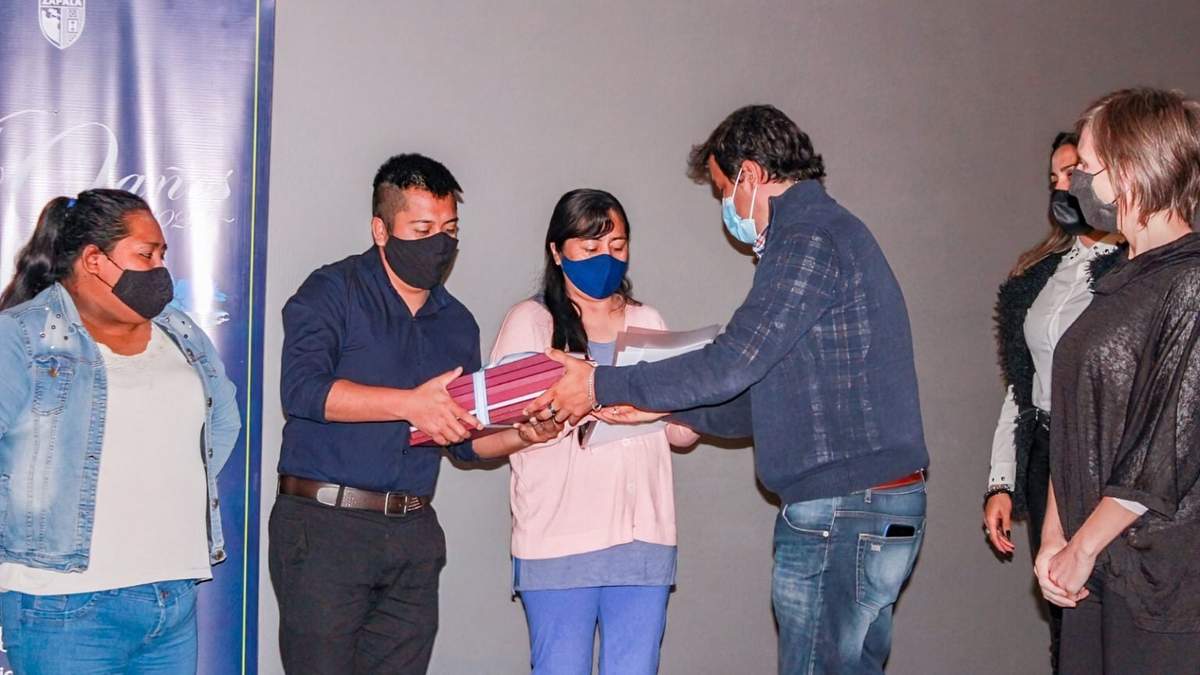 Carlos Koopmann entrega las matrículas a las personas responsables de tres cooperativas de trabajo. Fuente: (Twitter)