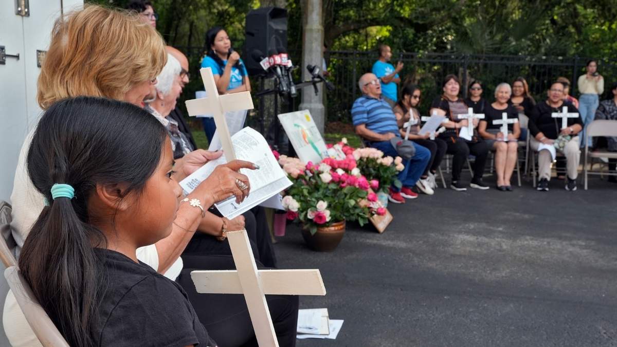 Personas oran durante una ceremonia en la Asociación de Trabajadores Agrícolas en Apopka, Florida