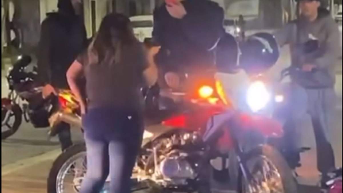 El motoquero que aceleró su moto para burlarse de la vecina que le reclamó por los ruidos. Sus amigos lo festejaban. Fuente (captura de video)